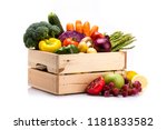 Pine box full of colorful fresh vegetables and fruits on a white background, ideal for a balanced diet, contains broccoli, cucumber, onion, asparagus, peppers, carrots, apple, grape, lima and potatoes