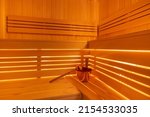 Light wooden Finnish sauna with accessories in the SPA center.