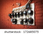 Old Electric Meters On A Red...