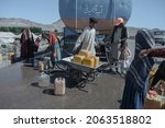 Small photo of The drought-displaced Afghan children fill water containers to carry to their tents from a tanker at a camp for internally displaced people on the outskirts of Herat province. Herat.2019