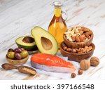 Selection of healthy fat sources on white wood background. 