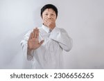 Small photo of Asian Muslim man covers his mouth with his hand and refrains from speaking, the concept of avoiding backbiting while fasting