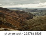 Small photo of Moody view down Grindsbrook Clough on Kinder Scout in the Peak District National Park in England on a moody day with low clouds and grey skies.