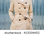 Woman in beige coat outdoors closeup