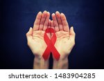 Small photo of Symbol of human immunodeficiency virus disease. Red ribbon. A helping hand and support. Background.