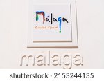 Small photo of Malaga, SPAIN - April 21 2022: Touristic sign of the city of Malaga with the slogan "Ciudad Genial" -´ Cool City.