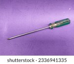 Crosshead screwdriver isolated purple background