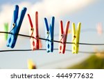 plastic clothes pins, laundry hook, colorful, pegs, rope ,outside, sun ,green, summer decorations, village, blue, sky , yellow ,red ,pins ,pink ,over
