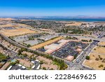Small photo of Drone photograph of the BART station in Pittsburg, California on a beautiful blue sky day.