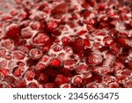 Small photo of Strawberry jam simmering slightly, detailed close-up, top view. Beautiful strawberry jam in cooking process. Boiling homemade strawberry jam. Making a homemade Strawberry Jam. Boiling fruit into a pan