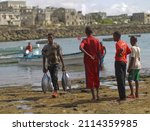 Small photo of Africa, Somalia - September 28, 2011 - In Mogadishu, the capital of Somalia, fishermen take the fish they catch in primitive methods to the market. Some fishermen carry giant sharks on their heads.