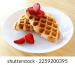 Small photo of Croffle or croissant waffle with strawberry slices. Perfect for recipe, article, catalogue, or any cooking contents.