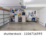 Organized clean suburban residential two car garage with tools, file cabinets and sports equipment.  