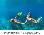 Happy family vacation. Young couple in snorkeling mask hold hand, free dive underwater with fishes in coral reef sea pool. Travel lifestyle, watersport adventure, swim activity on summer beach holiday
