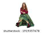 Small photo of Fashion photo of a beautiful elegant young teenager girl with long curly hair in the crown and a pretty long green skirl isolated on white background.