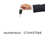 A businessman holding a car key on isolated background and clipping path