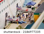 Small photo of People by the gangway getting on board of Carnival cruise ship docked in port of Nassau, Bahamas. June 20, 2022. Carnival Sunshine