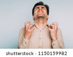 Small photo of infuriated rage and anger. man went berserk with fury. portrait of a young brunet guy on light background. emotion facial expression. feelings and people reaction concept.