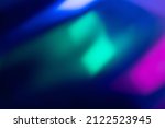 Neon blur glow. Color light overlay. Disco illumination. Defocused blue pink green ultraviolet radiance soft texture on dark abstract empty space background.