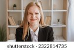 Small photo of Embarrassed expression. Mistake fail. Funny confusion. Cute ashamed blond young woman in business suit with wincing grimace in light interior.