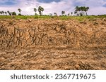 Small photo of Digging ditches, digging soil, digging ditches. Dig trenches for agriculture. Dig a long clay trench to lay pipes or fiber optics. Construction of a wastewater treatment and drainage system.