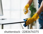 people doing cleaning are using cloths and spraying disinfectant Wipe the glass in the office room.cleaning staff, cleaning maid