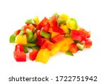 Pile of chopped fresh paprika in several colors over white background