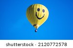 A yellow hot air balloon in the ...
