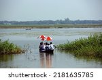Small photo of Taherpur, Bangladesh â€“ November 05, 2019: School students are in the middle of the river crossing the flood water to attend school in rural village. Students longing for education in spite of flooding