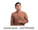 Handsome Asian Muslim man touching his stomach feels hungry and wants to eat delicious food isolated on white background. Ramadan and Eid Fitr celebration concept