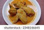 Small photo of Kare Ayam (Gulai Ayam) or Kari Ayam or Chicken Curry is Chicken Meat in turmeric and coconut milk soup. Served with ingredients garlic, onion, turmeric, lemongrass, nutmeg, chili, and others.
