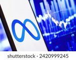 Small photo of META investment growth and profit trading concept. Meta company logo on screen of smartphone against blurred blue background of stock chart, USA, February 3, 2024