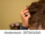 Small photo of nervously fumbling in hair, hand in light hair, boy at school, writing a test, concentration, overcoming stress