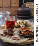 Small photo of Javanese traditional drink, Indonesia, namely Wedang Ginger Spice containing sliced â€‹â€‹ginger, secang, cardamom, deaf, cinnamon and Javanese sugar in hot water