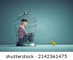 Man Inside A Bird Cage With A...