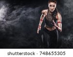 A strong athletic, woman sprinter, running on black background wearing in the sportswear, fitness and sport motivation. Runner concept with copy space.