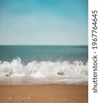 Small photo of Sand Beach and Hard Wave on Summer Sunny Day. Blue Ocean and Sky as background. Low angle View. Focus on Water Ripple Swash