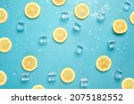 Lemon slices and ice cubes on a bright blue background, Contemporary food and drink refreshment summer vibes flat lay
