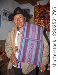 Small photo of Indigenous man with the ancient fabric called saddlebag