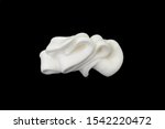 Small photo of whipped cream or meringue isolated on black background.
