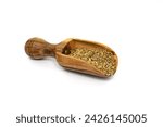Small photo of Dried anise seed (aniseed) in a wooden scoop isolated on white background.