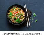 Pad Thai vegetarian vegetables udon noodles in a dark background, top view. Vegetarian food in asian style. Copy space 