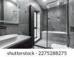 Small photo of Modern furnished bathroom dark grey interior design with granite tiles