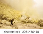 An Indonesian Sulfur Miner Working Down Hill in Ijen Crater Indonesia