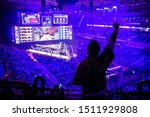 Small photo of MOSCOW, RUSSIA - 14th SEPTEMBER 2019: esports Counter-Strike: Global Offensive event. Fan on a tribune at tournament's arena with hands raised. Cheering for his favorite team.