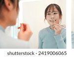 Small photo of A woman applying Vaseline on her lips