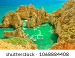 Aerial view of scenic landscape of boat trip between cliffs and natural rock formations of Ponta da Piedade in Lagos, Algarve, Portugal. Summer holidays. Tour tourism in Atlantic Ocean. Sunny day.