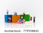 Small photo of Miniature people: sitting on book and read book for increase knowhow using as learning never ends, education concept.