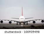 Airbus A380 jet airliner on runway - front view