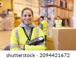 Small photo of Worker holding scanner in warehouse